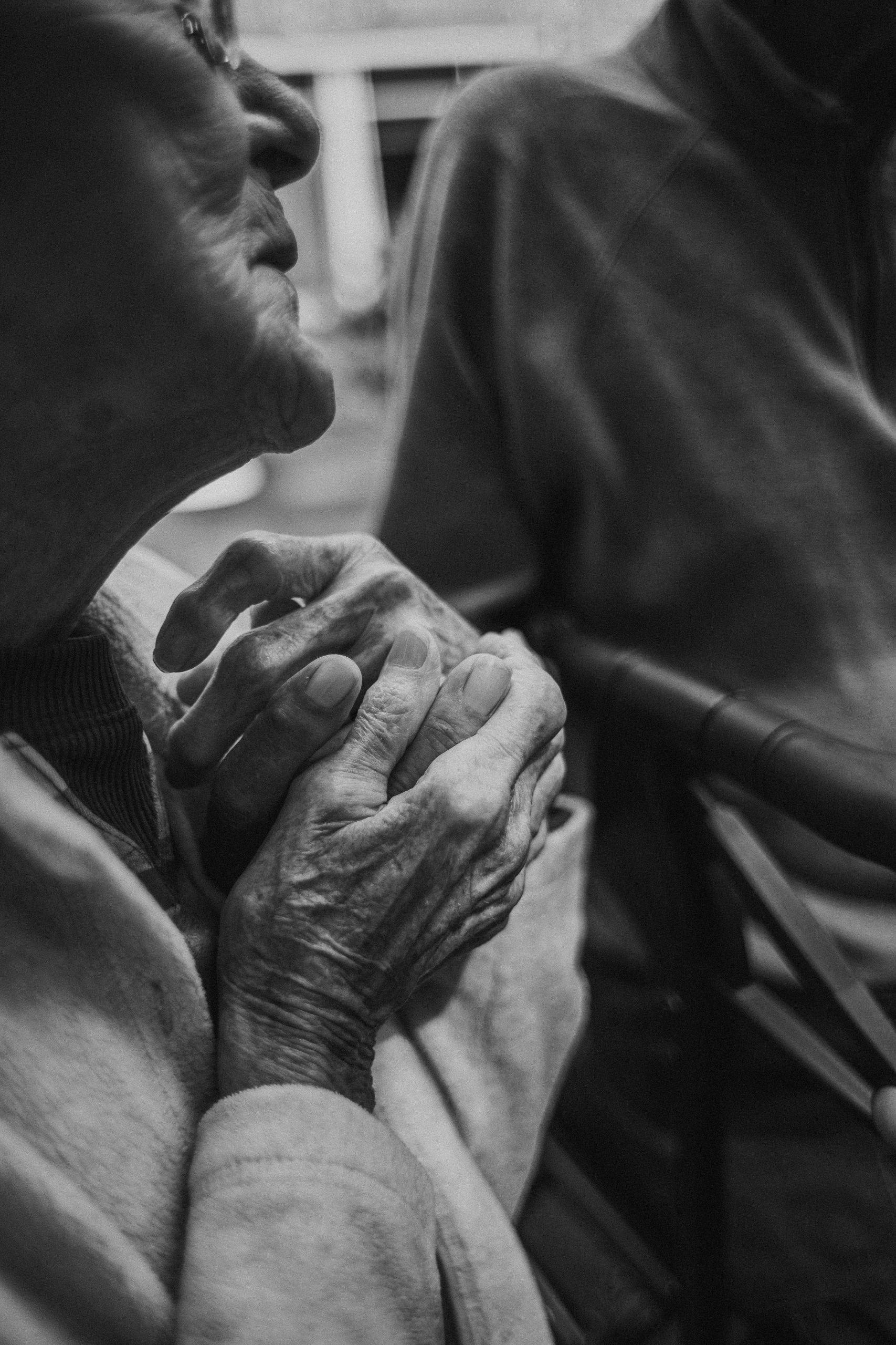 Elderly hands clasped together